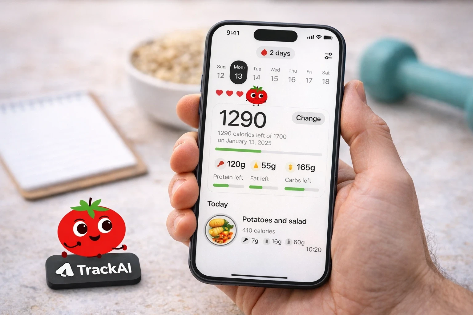 Hand holding a smartphone showing daily calorie intake and remaining calories.